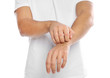 © New Africa - Young man scratching arm on white background, closeup. Annoying itch