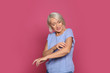 Mature woman scratching arm on color background. Annoying itch