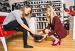 © Louis-Photo - A seller propose to try shoes to a female client