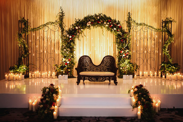 Wall Mural - Black sofa for Hindu wedding creremony stands on the stage