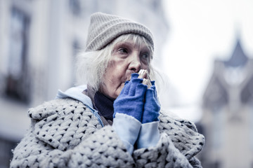 Wall Mural - Unhappy poor aged woman feeling very cold