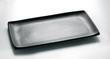 Black rectangular plate for sushi and asian cuisine top view on a white background