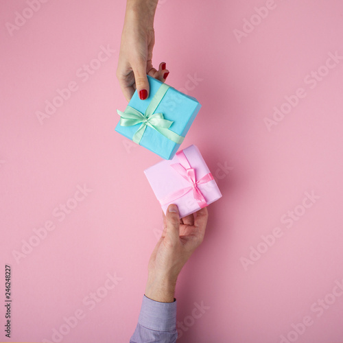 man and girl exchanging gifts from hand to hand,boxes wrapped in ...