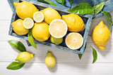 Fresh  organic lemon fruits with leaves on wooden table. Healthy food concept. Vitamin C