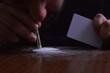 Person with a dollar bill snorting cocaine