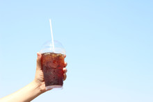 Woman Holding A Plastic Iced Black Coffee