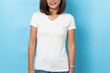© suriya - Portrait of asian woman in a blank white T-shirt on blue background Mock-up