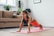 © undrey - Little girl doing plank exercise at home.