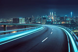 Fototapeta  - Highway overpass motion blur with city background .night scene
