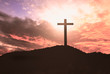  Concept of Jesus Christ: white cross on sunset sky background