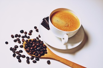 Hot cup of coffee with beans and chocolate on white background