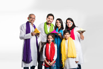 Wall Mural - Indian Family taking selfie picture on Holi festival while holding sweets and colours