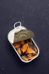 Wall Mural - mussels canned food on black ceramic background