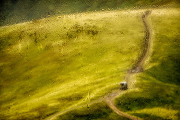 Wall Mural - Water droplets on a window pane with beautiful defocused scenery outside.