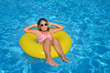 © SuperCoolPhotography - Real adorable girl relaxing in swimming pool