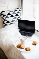 Wall Mural - Cozy everyday breakfast with laptop, cup of coffee and cookies