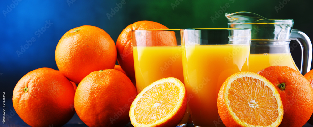 Glasses with freshly squeezed orange juice - obrazy, fototapety, plakaty 