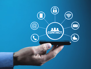 Wall Mural - man holding phone with contact icons.