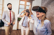© Mediteraneo - Business people making team training exercise during team building seminar using VR glasses