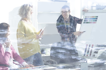 Wall Mural - view through the glass wall. a group of fashion designers discussing new ideas