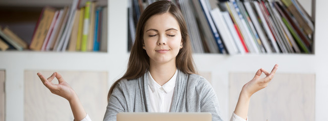 horizontal photo businesswoman employee student meditating sitting near laptop at workplace, stress 