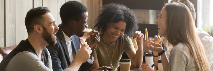 Five friends drinking coffee eating pizza at cafe, diverse people laughing tell jokes having fun in public place, multiracial friendship free time concept, horizontal banner for website header design