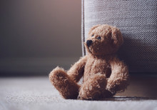 Teddy Bear Is Laying Down On Carpet In Retro Filter, Lonely Teddy Bear Laying Down Alone In Living Room At Night ,lonely Concept, International Missing Children's Day.