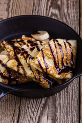 Canvas Print - Crepes with bananas and chocolate topping for breakfast