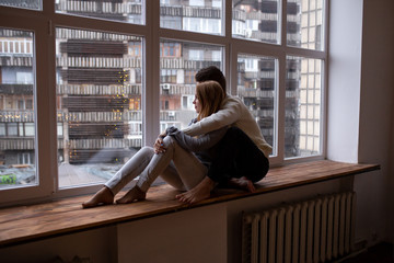 Valentines Day. Loving couple hugging and has fun in their bedroom near the window