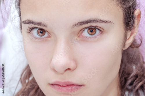 Portrait Of A Young Girl S Face With Bright Brown Eyes