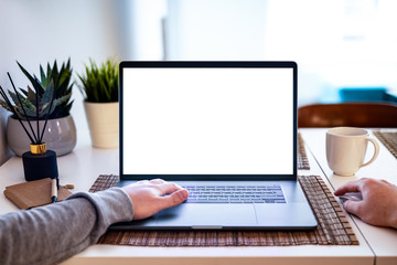 Man hands using Notebook with blank screen on table in office interior building - mockup, template