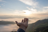 Fototapeta Mapy - Hands outstretched to receive natural light and mountain views, beautiful morning fog. hipster style.