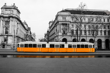 Wall Mural - A picture of the typical yellow tram in Budapest, Hungary. The tram is isolated in the black and white background.