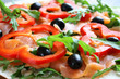 Smoked salmon, red pepper, arugula and black olives on a tortilla