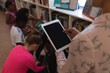 © wavebreak3 - Female teacher working on digital tablet in school library