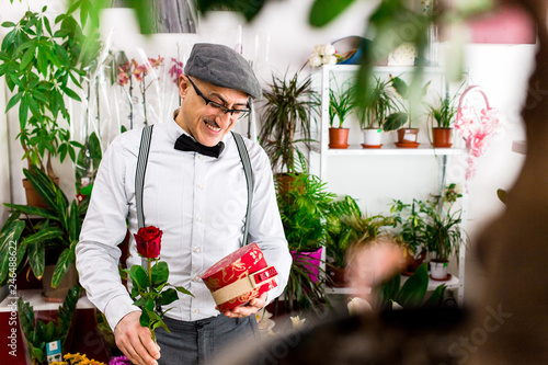 Husband Buying Flowers And Gifts For Valentine S Day For His Wife In Local Flower Shop Happy With His Choice Buy This Stock Photo And Explore Similar Images At Adobe Stock
