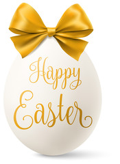 Wall Mural - white easter egg with a golden bow and happy easter text isolated