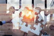 Business people work together to build a puzzle. Concept of teamwork, partnership, integration and startup. double exposure
