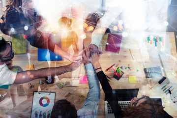 Wall Mural - Business people putting their hands together. Concept of integration, teamwork and partnership. Double exposure