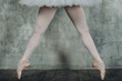 Ballerina beautiful legs. Young beautiful woman ballet dancer, dressed in professional outfit, pointe shoes and white tutu.