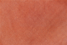 Texture Of Genuine Geometric Perforated Leather Close-up, Painted Orange Brown Color. For Background, Backdrop.
