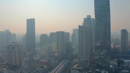 Wall Mural - Bangkok central business downtown, heavy traffic aerial view. Top view of hazy Thailand's capital. Big city life, transportation, infrustructure and developing country concept.