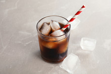 Glass Of Refreshing Cola With Ice On Grey Background