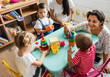 © Rawpixel.com - Nursery children playing with teacher in the classroom