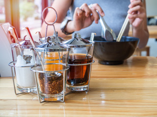 Thai-style noodles seasoning set on wooden table