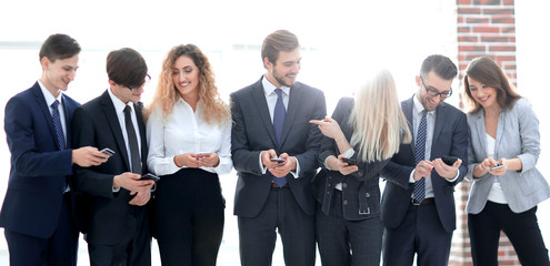 Wall Mural - business team looking to smartphone in office