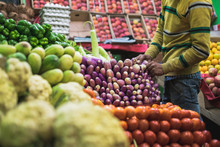 A Man Arranging Vegetables And Fruits At A Shop In Downtown Leh Ladakh In Northern India.