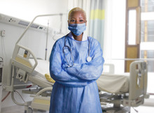 Attractive And Confident Black African American Medicine Doctor Wearing Face Mask And Blue Scrubs Standing Corporate In Health Care Work Concept At Hospital Room