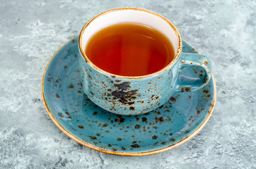 Hot tea in blue cup and saucer