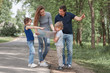 © yurolaitsalbert - family with a road map standing on the side of the road. f